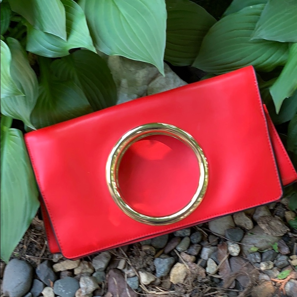 Bright red clutch with gold accent.